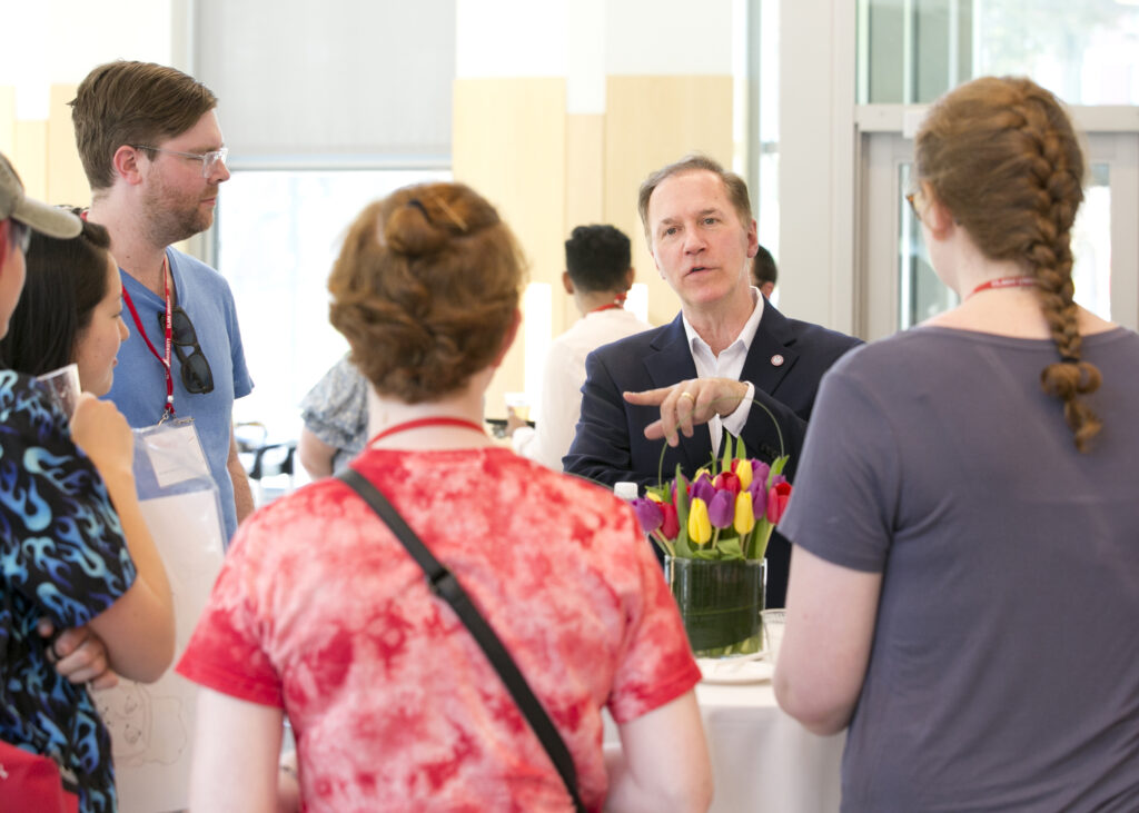 People talking during LGBTQ+ Alumni Reunion Reception