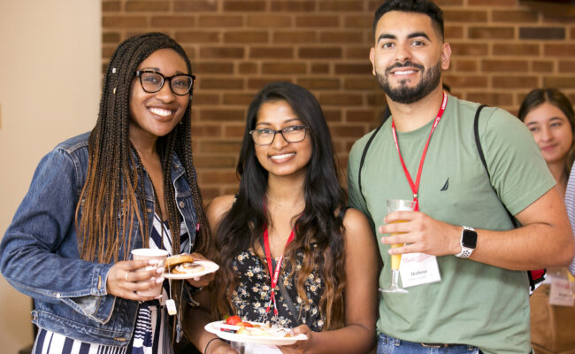 Smiling people talking during Clark's BIPOC Alumni Reunion Reception