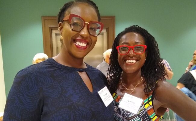 Photo of two women at the "can i touch it?" Performance and Clark Reception