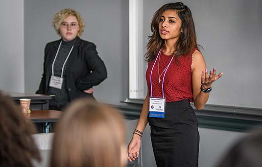 A student presenting at a conference
