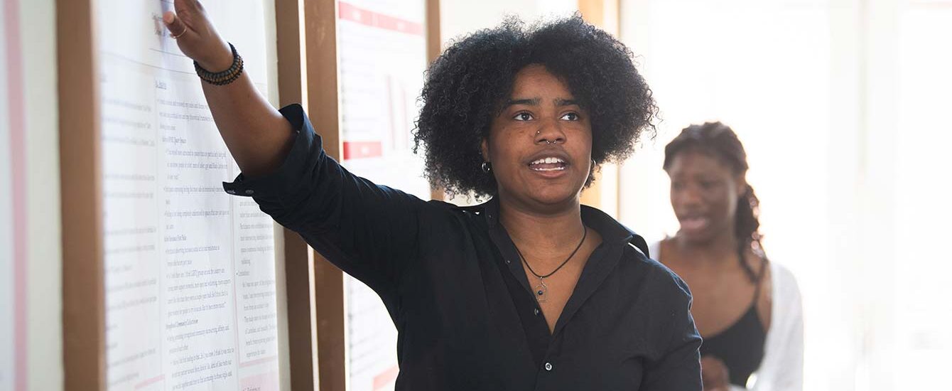 A student presents research on a topic connected to hate-based violence