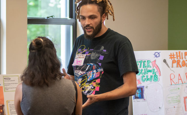 male student showing project