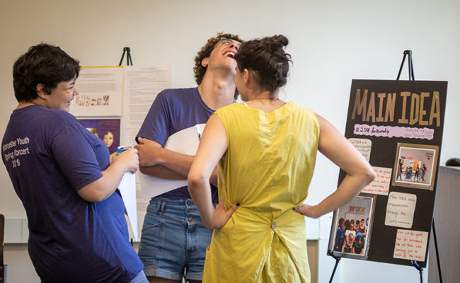 Three students connecting and laughing
