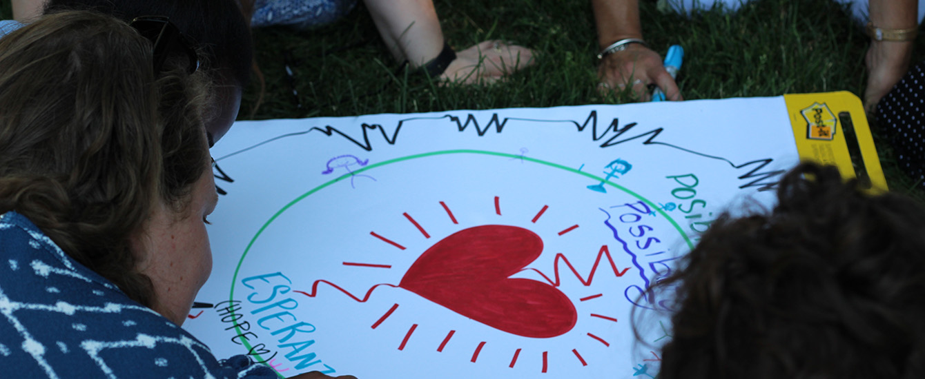 children creating poster with teacher