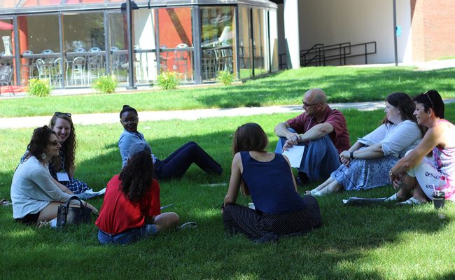 teachers sittng on campus green law
