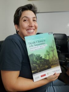 Pilii holding up book