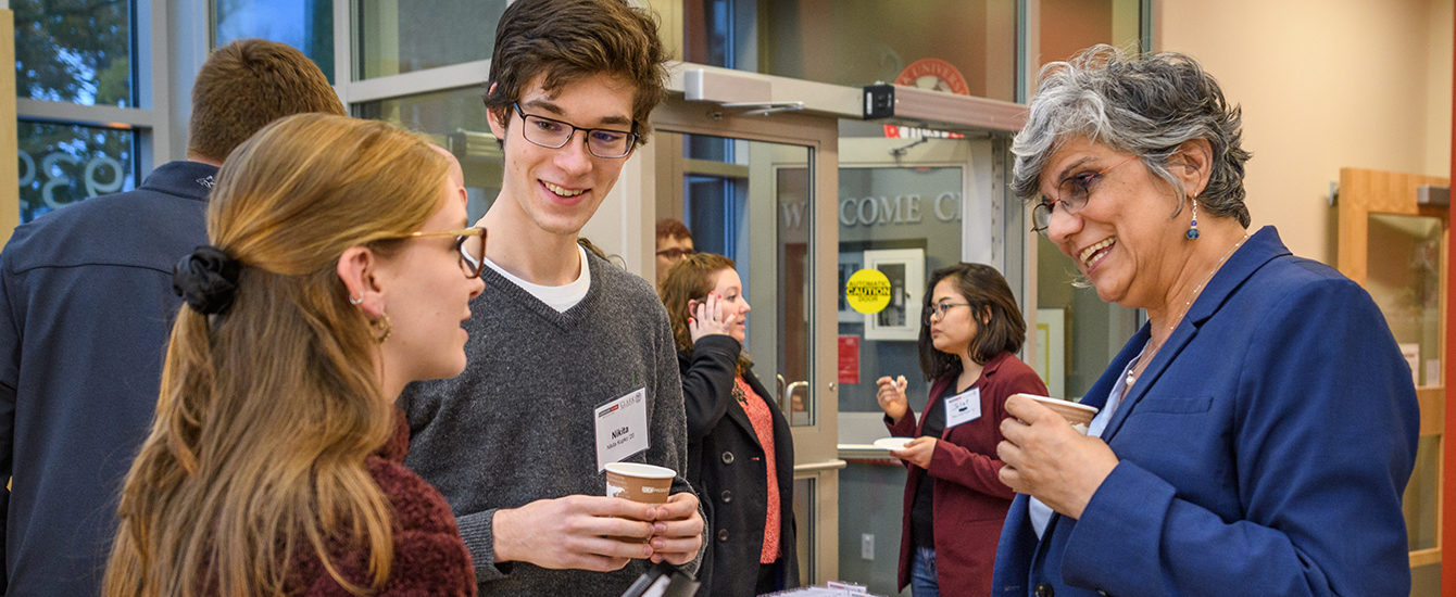 students networking with alumn