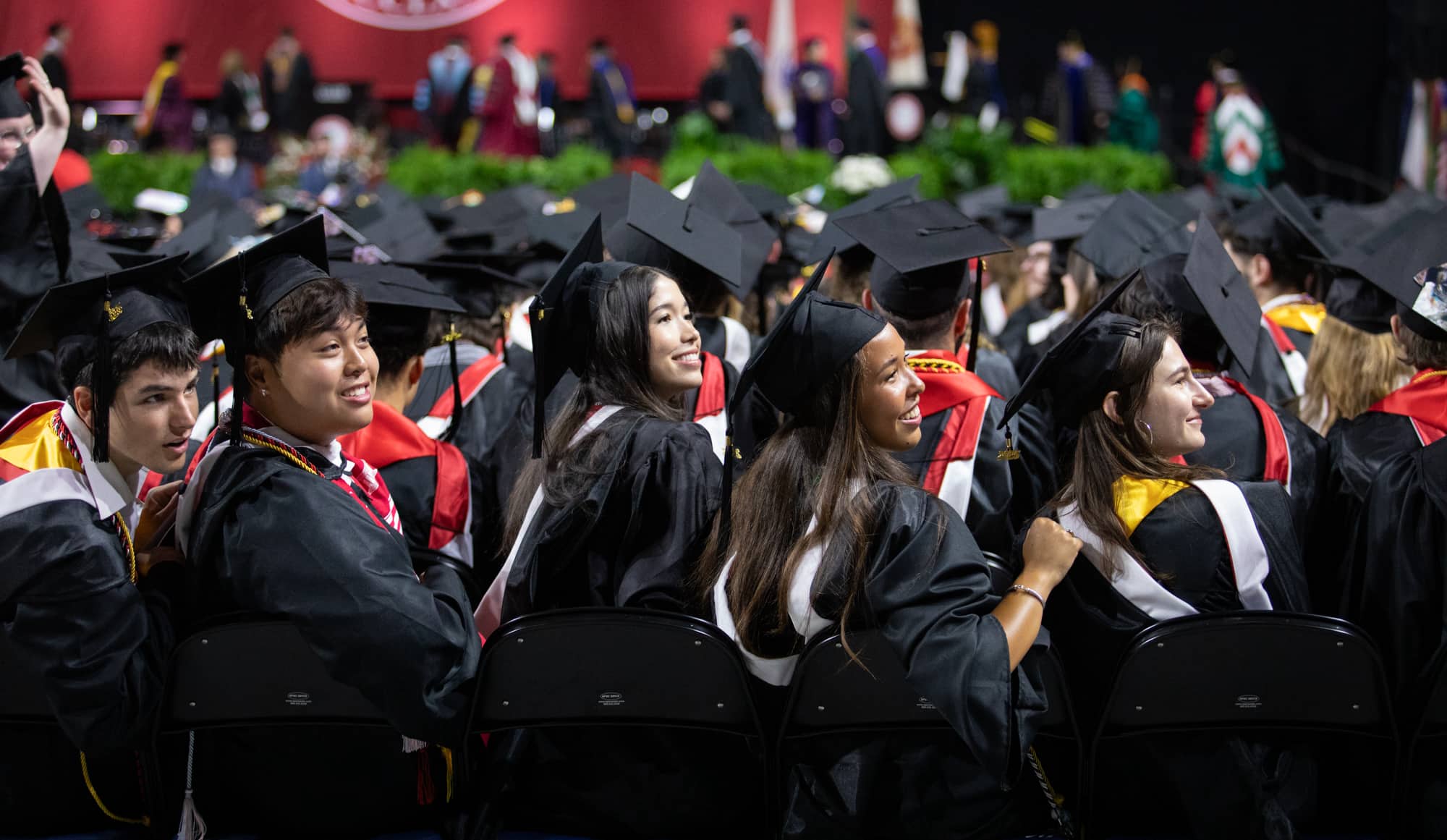 graduates watch their fellow students enter