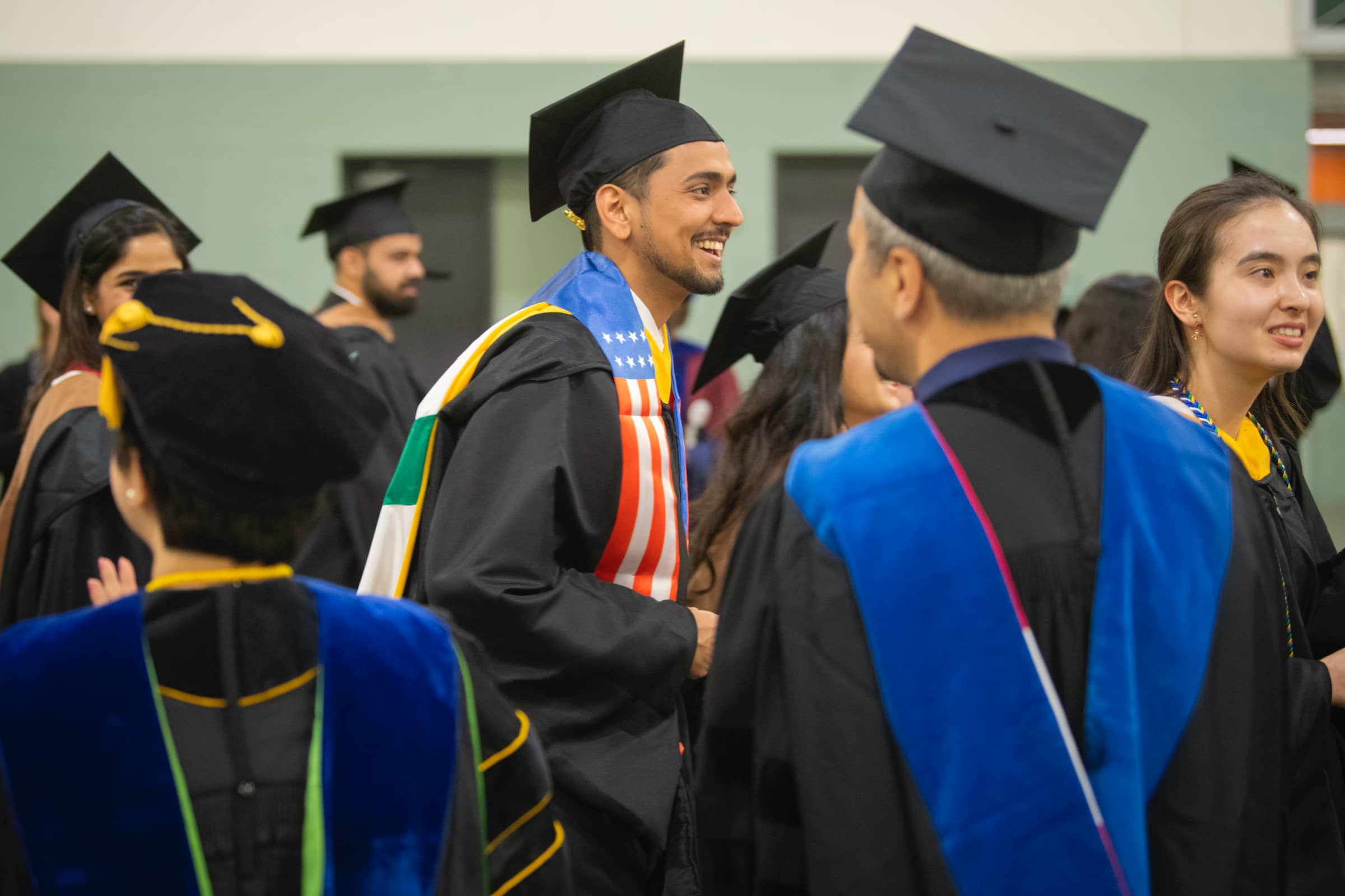 a graduate prepares for the ceremony