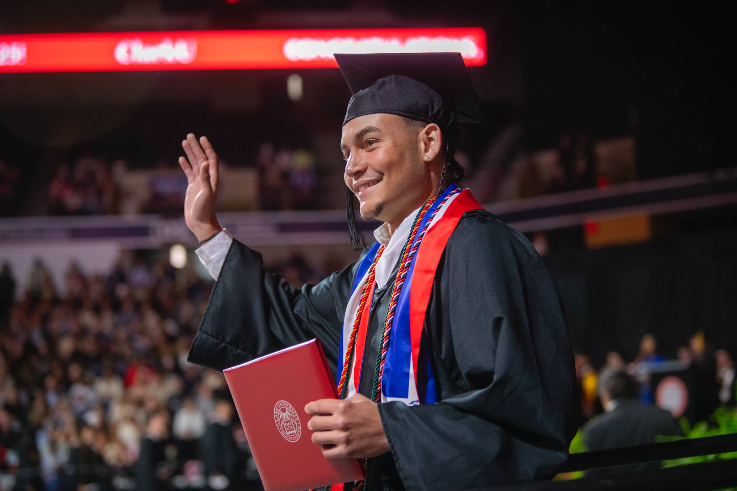 a graduate shows his newly acquired diploma