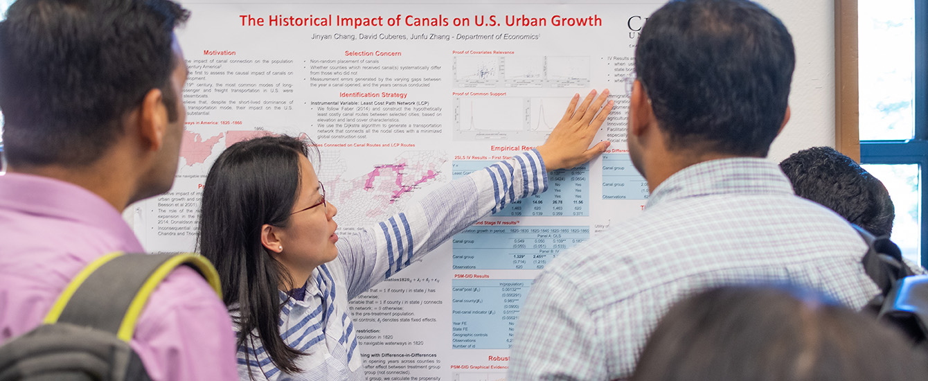 Student pointing at research poster