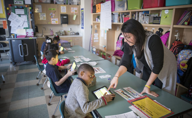 female teacher working with student