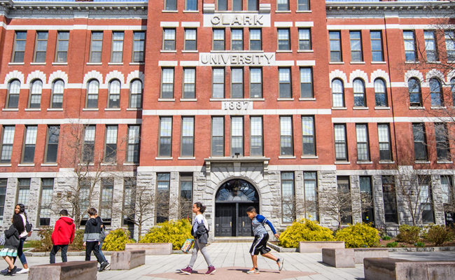 Elementary students walking in front of Clark University's Jonas Clark Hall