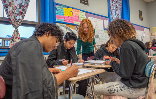 female teacher teaching students as part of internship