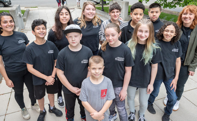 young k-12 students with college intern studen