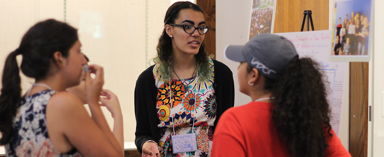 teacher talking to young female student