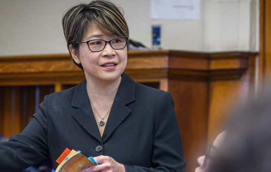 Professor Betsy Huang talks to students in a classroom