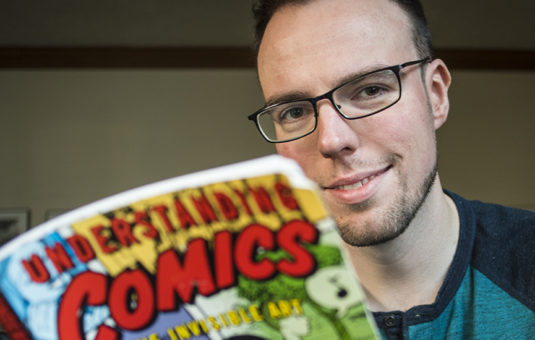 Student holding a comic book