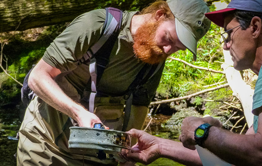 Student taking water sample