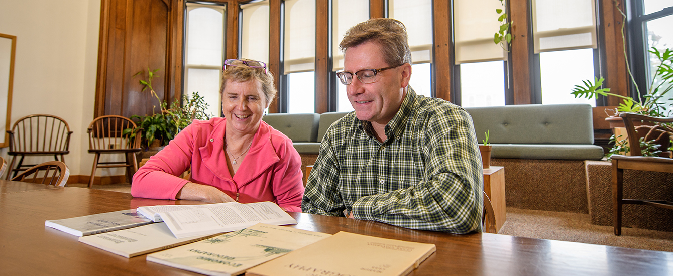 Professors looking over books for Urban Economic Geography
