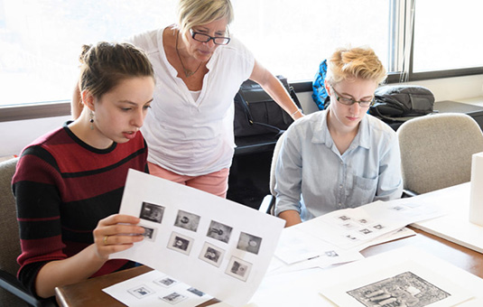 Students looking at images with professor