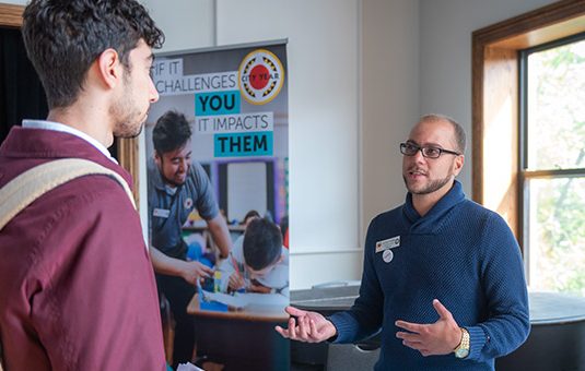 Student talking to employer at career fair