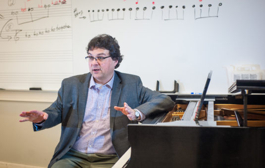Professor sitting at piano