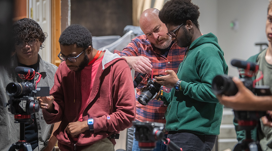Professor and students working in the Intro to Digital Filmmaking course