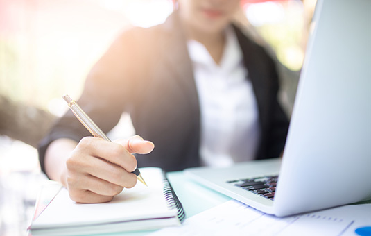 Woman writing in a notebook