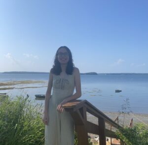 Sophia standing on the beach smiling