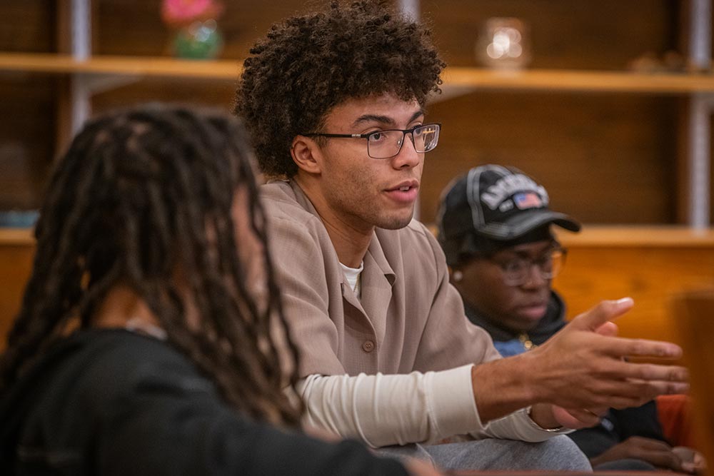 Aedan Derrick ’26 participates in a group discussion at a gathering of the Men of Color Alliance