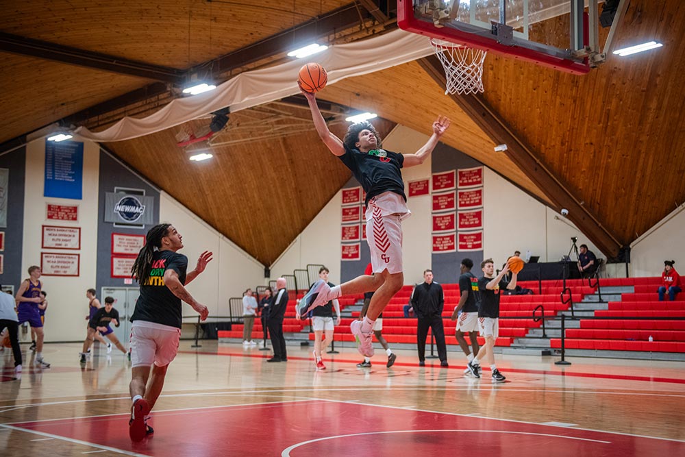 Aedan Derrick ’26 goes up for a layup before a men’s varsity basketball game.