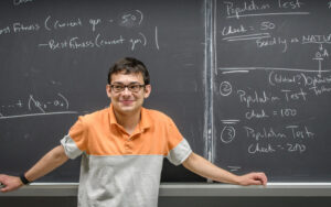 mathematics student at chalk board with math example
