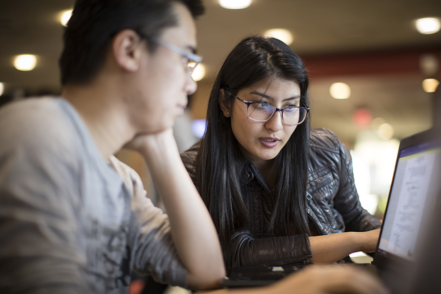 students looking at laptop