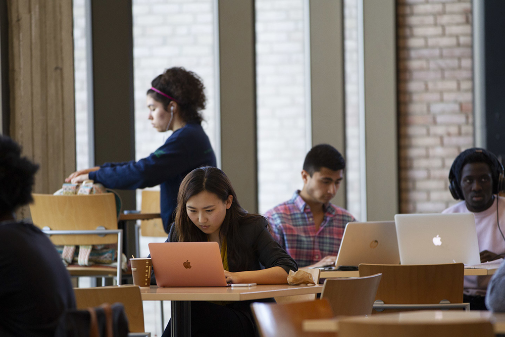 students studying at desks in library