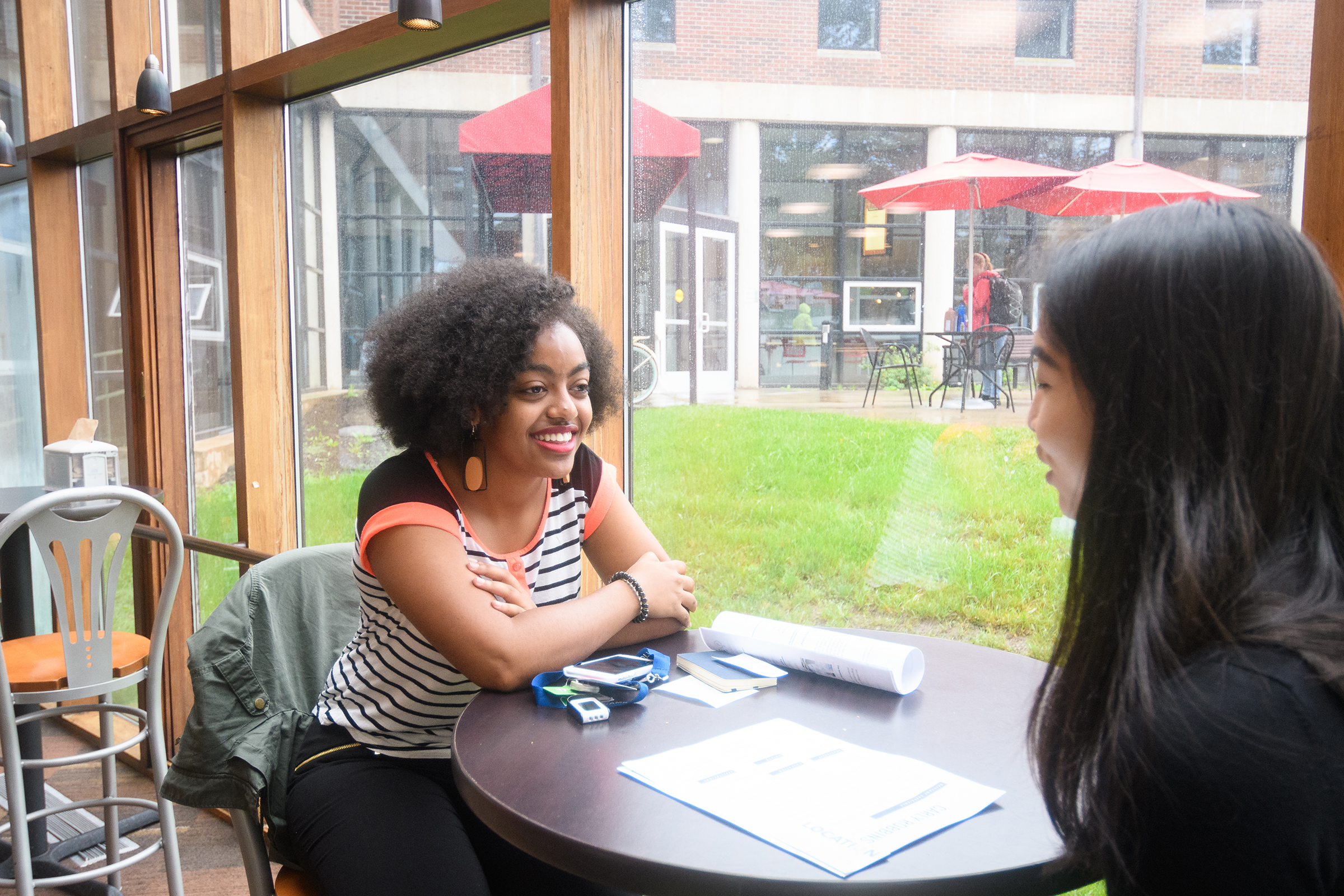 Higgins University Center - two female students sitting in bistro
