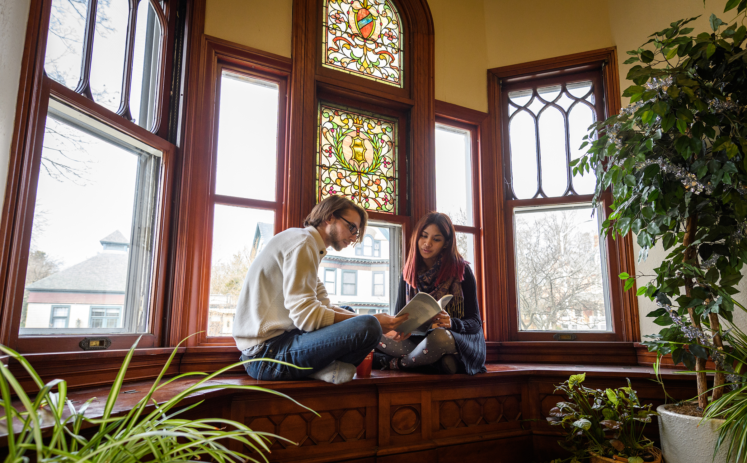 Anderson House with two students sitting in stairwall