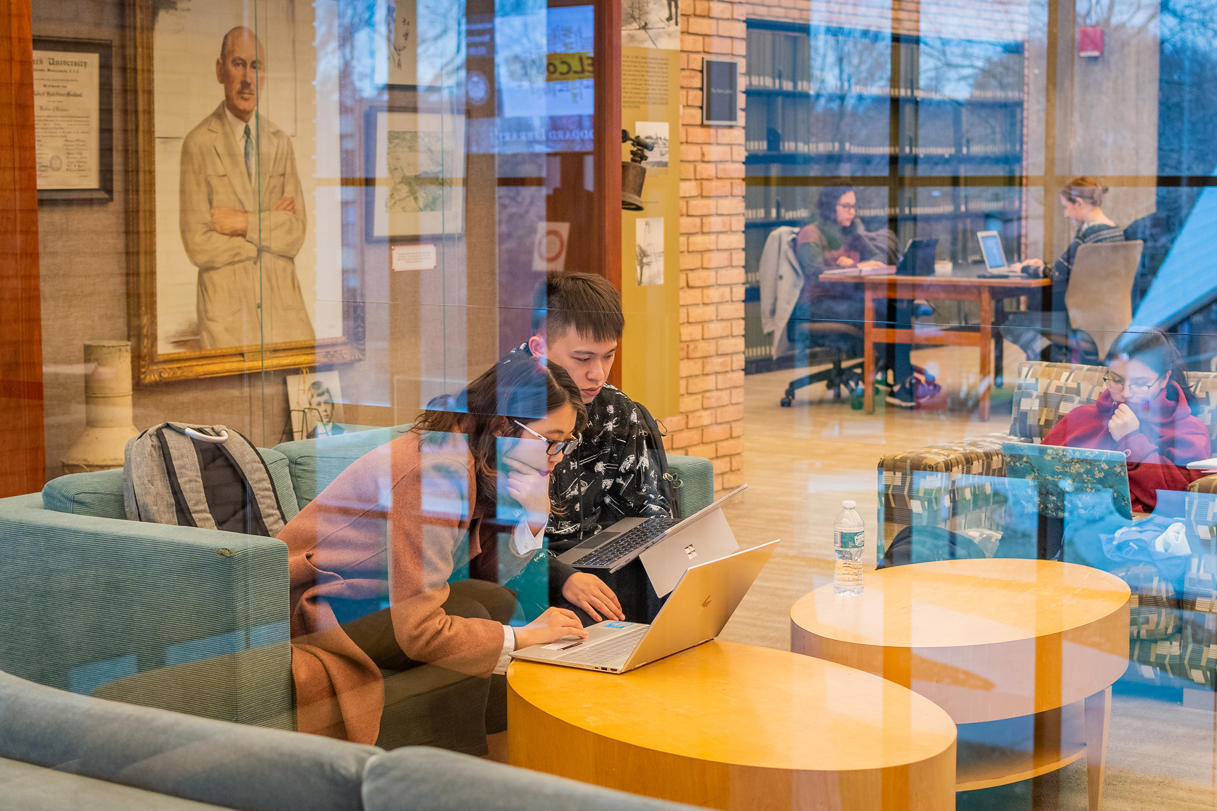 Goddard Library - students in library behind glass wall