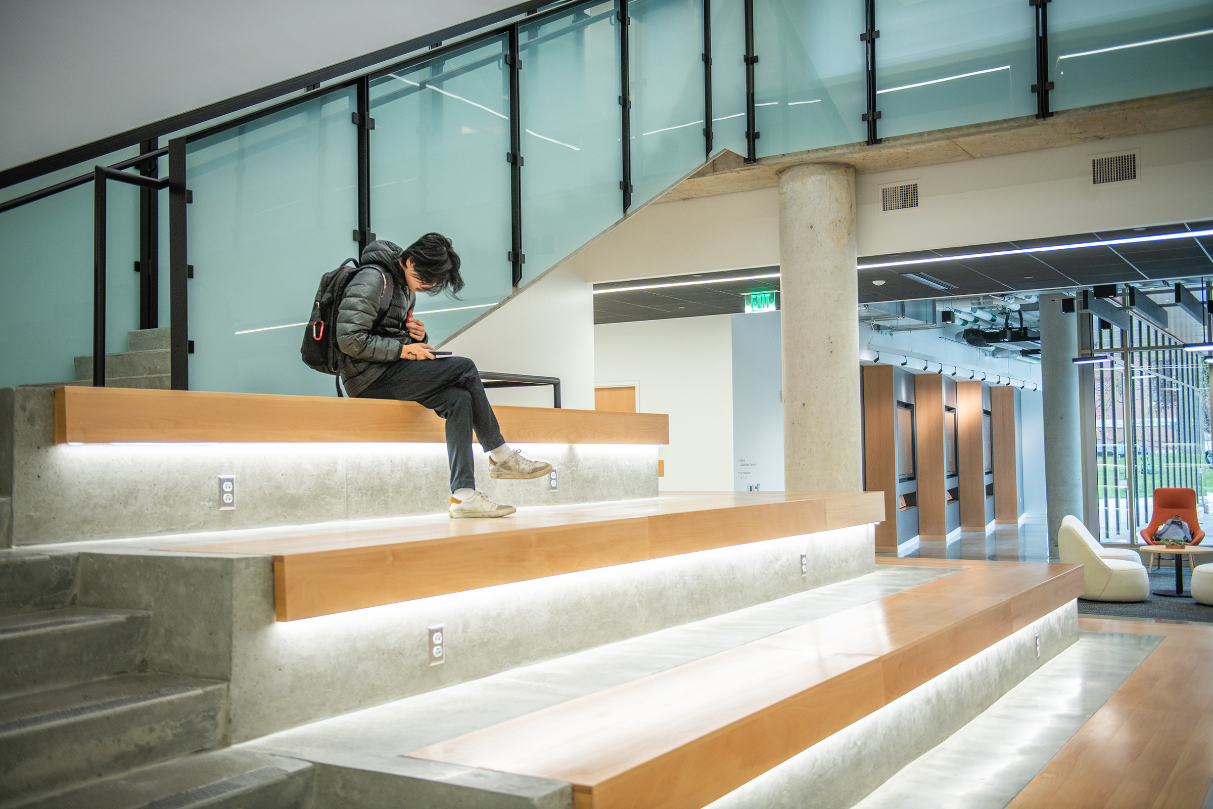Center for Media Arts, Computing, and Design Building - student sitting on staircase
