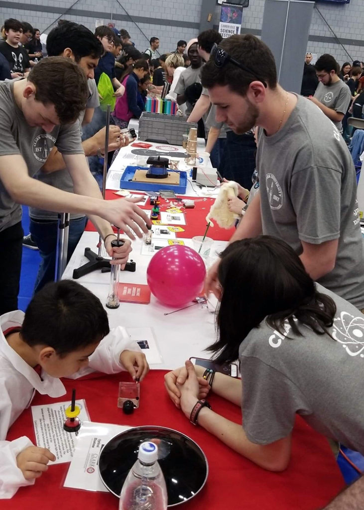 Physics students conduct experiments with Cambridge Science Festival attendees.