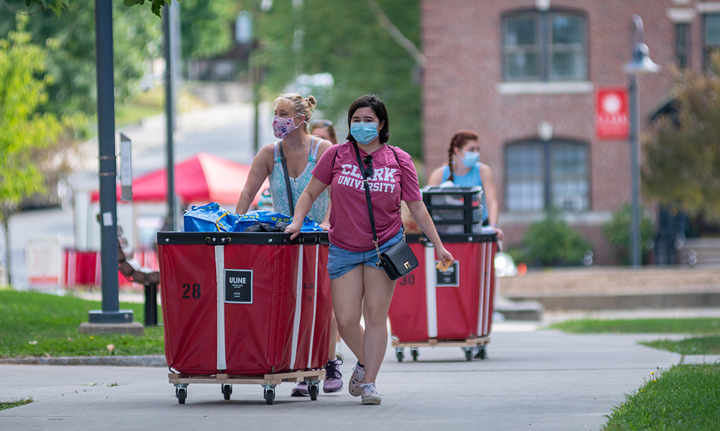 Students in mask moving their stuff on campus