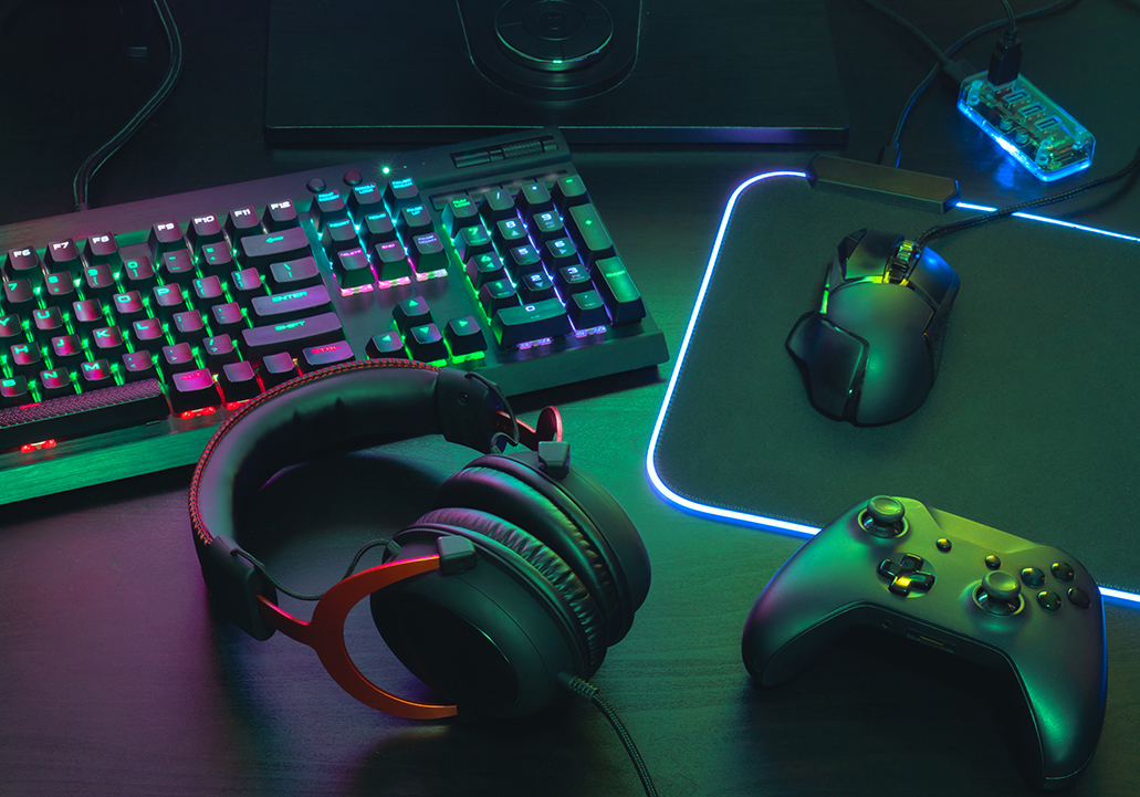 Gamer workspace with mouse, joystick, keyboard, headphones