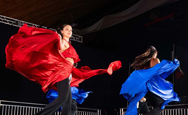 A student performs a dance a the 2024 Gala that incorporates a long, red skirt