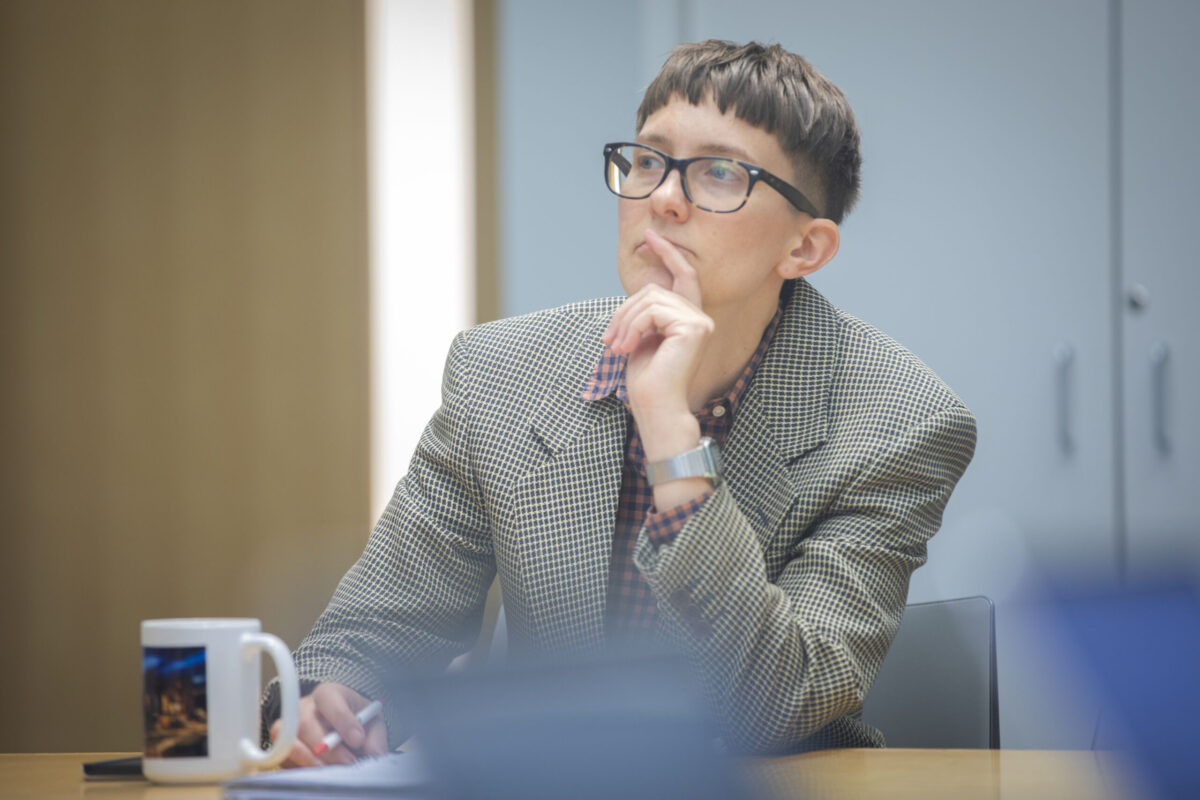 professor sits at table
