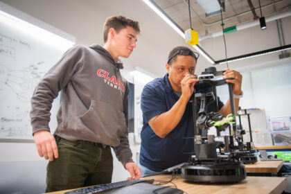 student and professor work in robotics lab