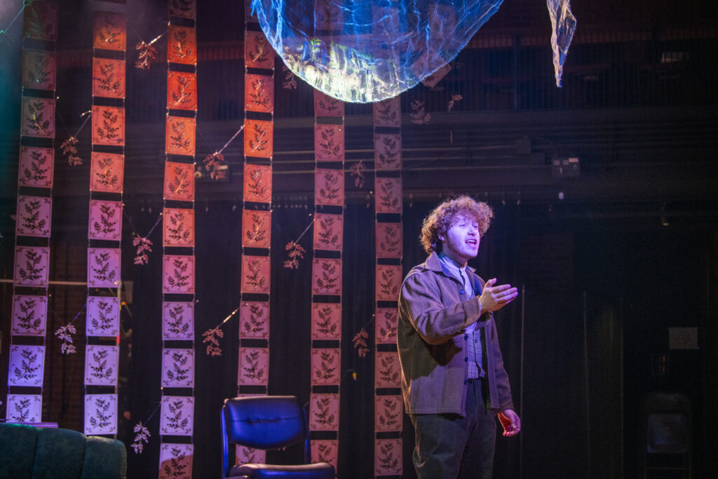 student rehearsing play on stage