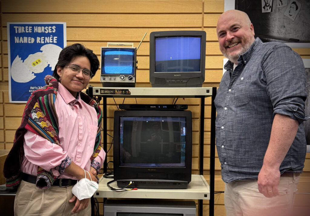 student and professor pose for photo