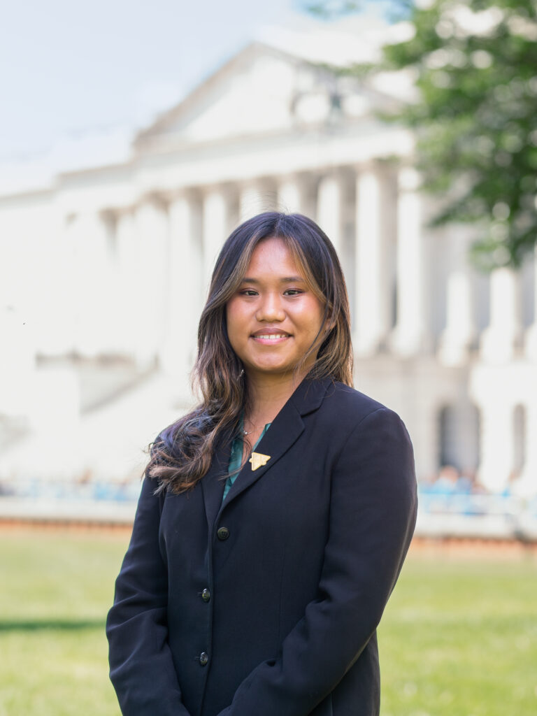 student headshot in front of white building