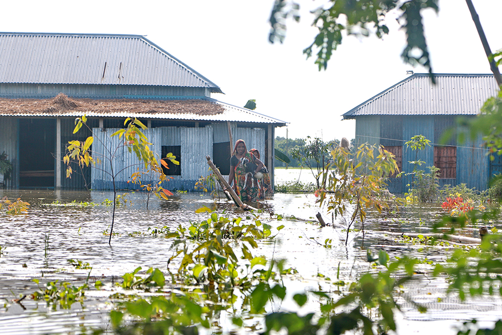 Residents of Bangladesh travel through floods to higher ground