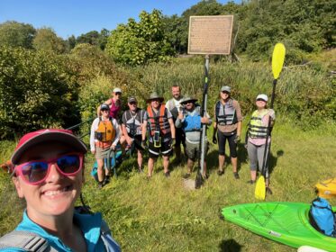 kayakers pose for photo off river